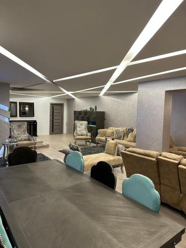 a large living room with a large table and couches at Trio villa with falls in compound فلا بحديقة كبيره وشلالات صناعية in Sheikh Zayed