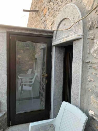 a door to a patio with a table and a chair at Medieval House in Mesta