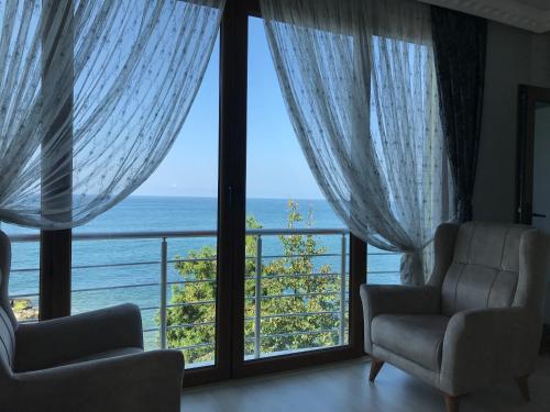 a living room with a view of the ocean at Seafront Apartment Rize-Ardeşen in Ardeşen