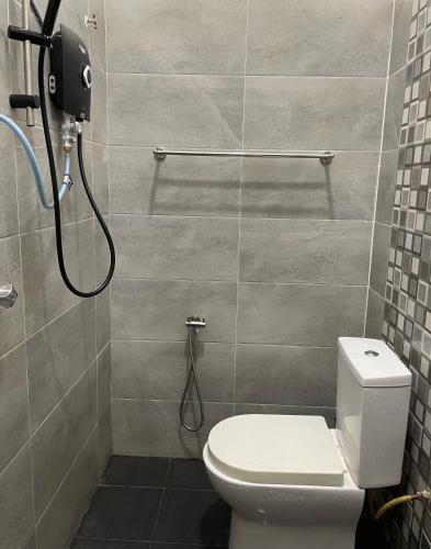 a bathroom with a toilet and a shower at Homestay Husna in Dungun