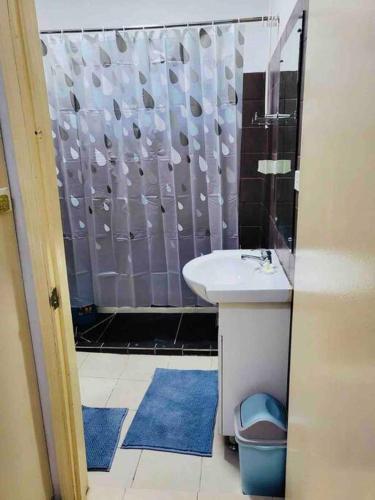 a bathroom with a shower with a sink and a toilet at Cozy, Comfortable, Family Home. in Nadi
