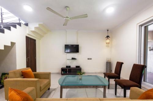 a living room with a couch and a table at Serene Villa by StayVista - A Hill-View Villa with Plunge pool in Karjat