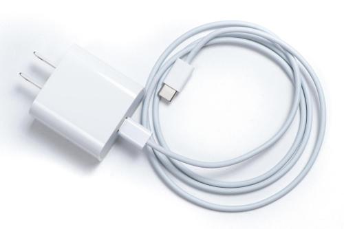 a white ipod nano plugged into a usb adapter at Hotel Katsuyama Premiere in Matsuyama