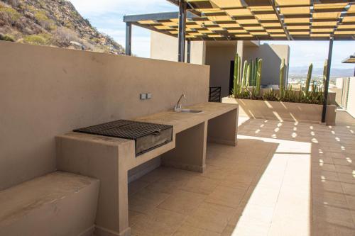 a bathroom with a sink on top of a building at NEW Terra Condo w/ Infinity Pool in Cabo San Lucas