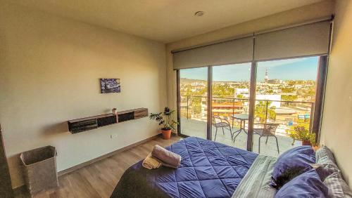 a bedroom with a bed and a large window at NEW Terra Condo w/ Infinity Pool in Cabo San Lucas