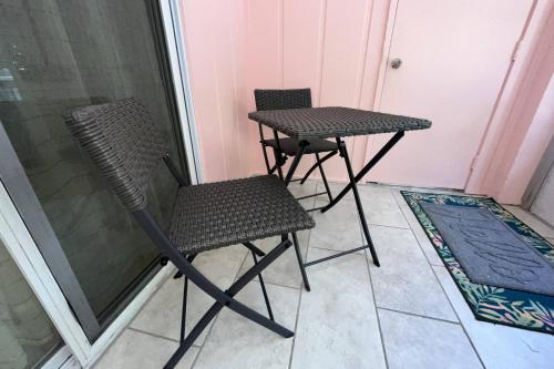 two chairs and a table on a balcony at Beachy 2-1 Condo in Palm Harbor