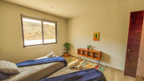 a bedroom with two beds and a window at NEW Terra Condo w/ Infinity Pool in Cabo San Lucas