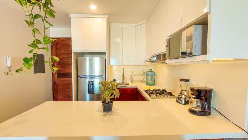 a kitchen with a sink and a stove top oven at NEW Terra Condo w/ Infinity Pool in Cabo San Lucas
