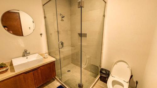 a bathroom with a shower and a toilet and a sink at NEW Terra Condo w/ Infinity Pool in Cabo San Lucas