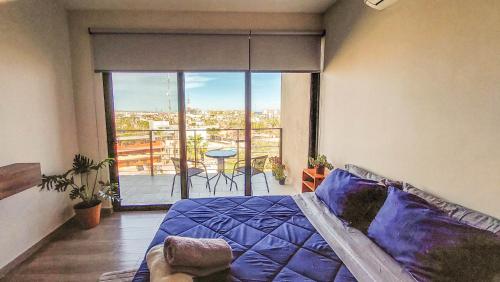 a bedroom with a bed and a balcony with a view at NEW Terra Condo w/ Infinity Pool in Cabo San Lucas