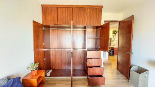 a room with a wooden closet with a wooden door at NEW Terra Condo w/ Infinity Pool in Cabo San Lucas