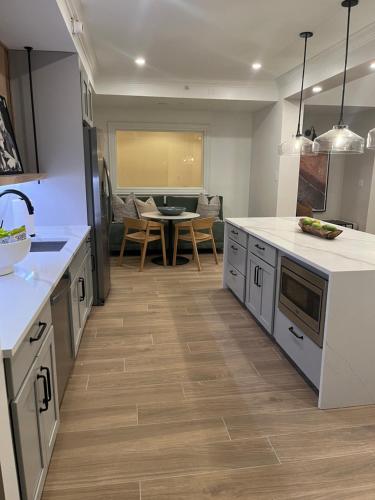 a kitchen with white counters and a dining room at Blooming Journey in Tampa Bay! in Tampa