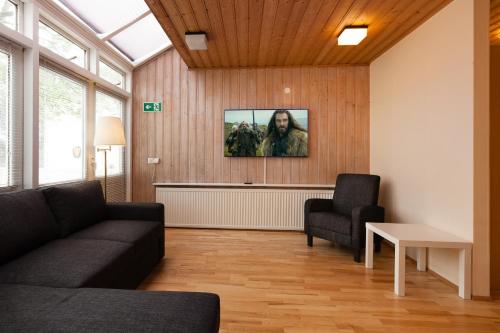 a living room with a couch and a chair at Guesthouse Galtafell in Reykjavík