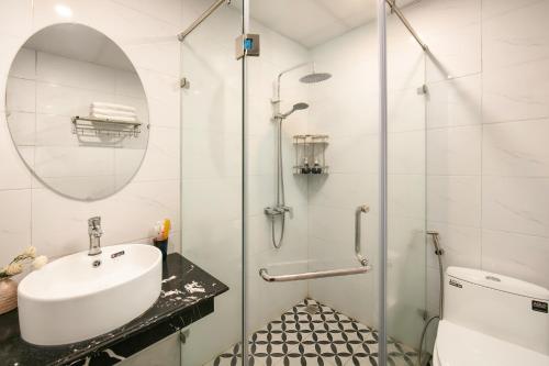 a bathroom with a sink and a shower at La Renta Premier Hotel & Spa Hanoi in Hanoi