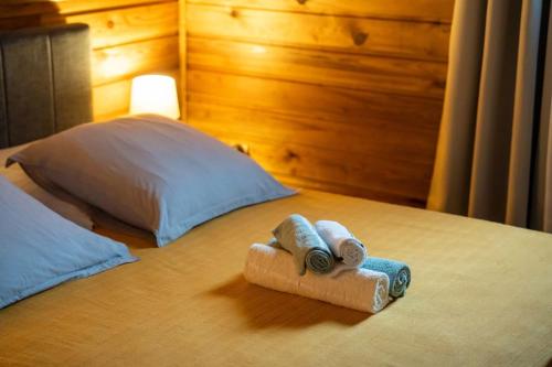 a pair of towels sitting on top of a bed at La Chrysalide du Bassin - DODOTERLA in Saint-Joseph