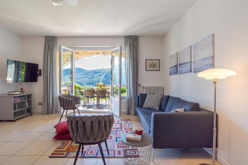 a living room with a couch and a table at Villa Tremezzo in Tremezzo
