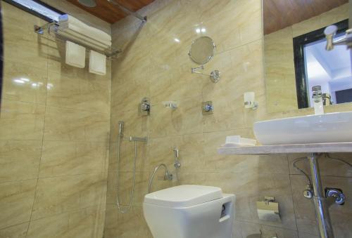 a bathroom with a shower and a toilet and a sink at Hotel S R Castle in Port Blair