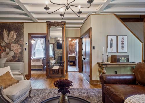 a living room with a couch and a mirror at Luxuriously Restored Farm Cabin in Mountainhome