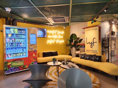 a store with a soda machine and tables and chairs at lyf Chinatown Kuala Lumpur in Kuala Lumpur
