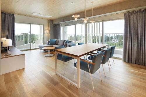 a dining room with a table and chairs at BEB5 Okinawa Seragaki by Hoshino Resorts in Onna