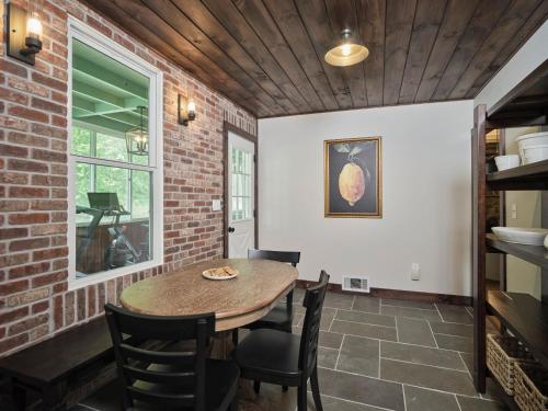 a dining room with a table and chairs at Luxuriously Restored Farm Cabin in Mountainhome