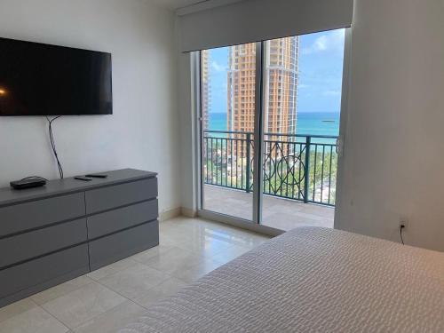 a bedroom with a bed and a view of the ocean at The King David Condos in Miami Beach