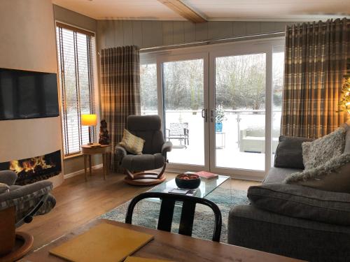 a living room with a couch and a fireplace at The Floating Home at Upton in Upton upon Severn
