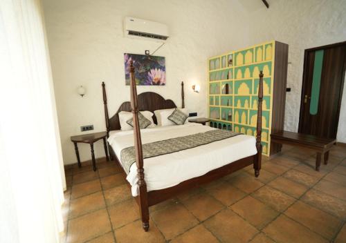 a bedroom with a large bed with a wooden frame at Waterstone resort in Linga