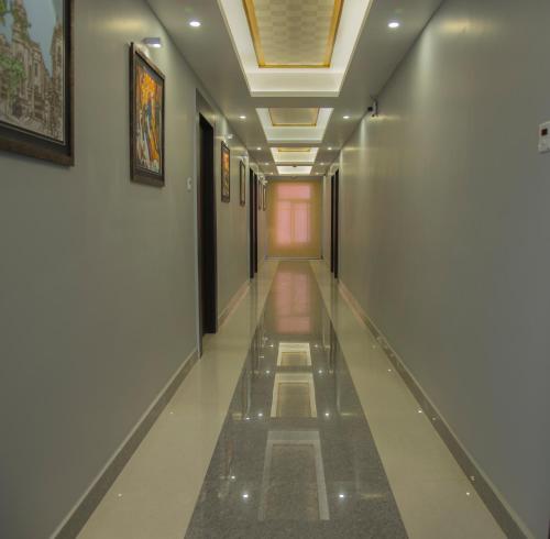 a long hallway with white walls and a long aisle at Hotel S R Castle in Port Blair
