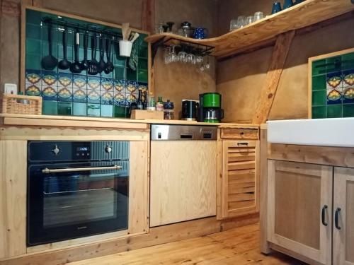 a kitchen with wooden cabinets and an oven at Ländliches Wohnen zwischen Erfurt und Gotha in Erfurt