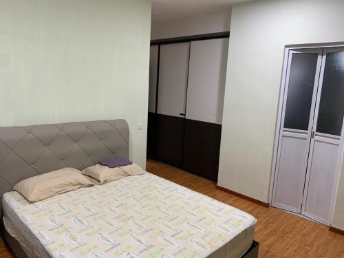 ein Schlafzimmer mit einem Bett und einem großen Schrank in der Unterkunft Ortega Villa in Kuching