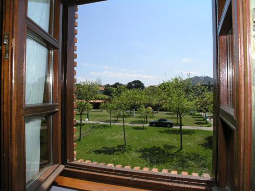 an open window with a view of a park at Hotel Costa San Juan De La Canal in Soto de la Marina