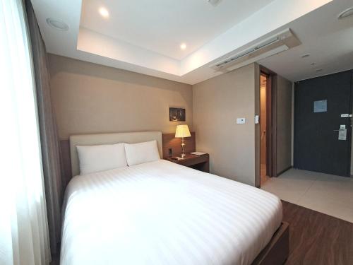 Katil atau katil-katil dalam bilik di Busan Business Hotel