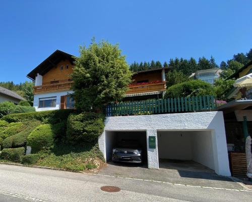 a car parked in a garage in front of a house at Haus Otis in Millstatt