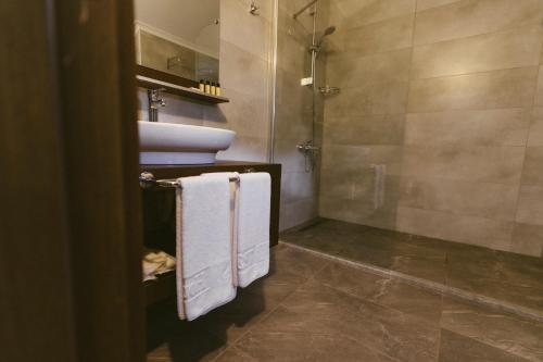 a bathroom with a sink and a toilet and towels at WEST HOUSE EXCLUSIVE HOTEL in Göcek