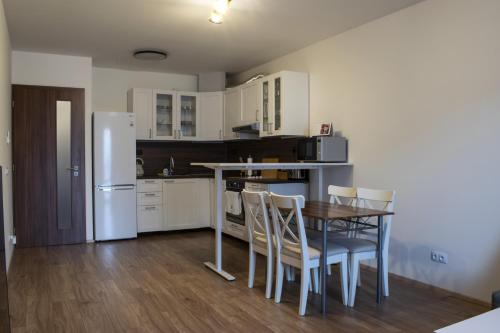 a kitchen with a table and chairs and a refrigerator at Central Prague Vítkov - free parking in Prague