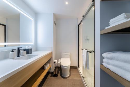 a bathroom with a sink and a toilet at Hotel Mai Downtown Long Beach in Long Beach