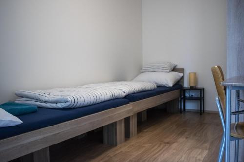 a bed sitting on a wooden bench in a room at Central Prague Vítkov - free parking in Prague