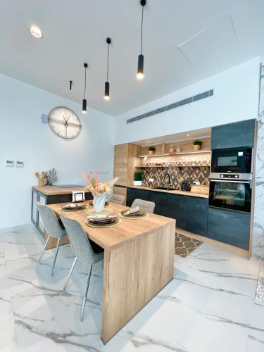 a kitchen with a wooden table and chairs at Rosella Chalet 2 in Jabal Al Akhdar