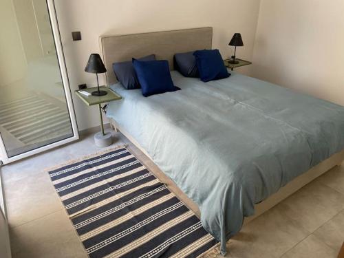 a bedroom with a large bed with blue pillows at House center of Athens, near Acropolis in Athens