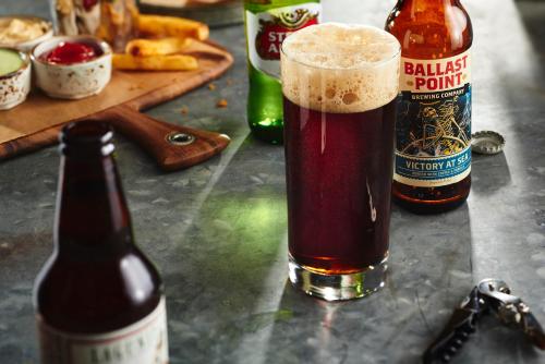 two bottles of beer sitting on a table at Courtyard by Marriott Pune Chakan in Chakan