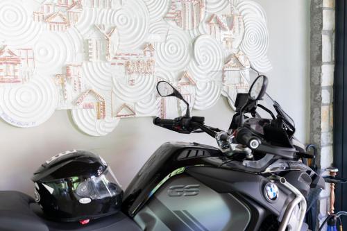 a black motorcycle parked in front of a wall at WEST HOUSE EXCLUSIVE HOTEL in Göcek