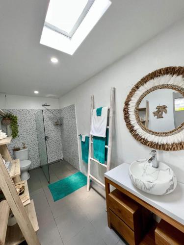 a bathroom with a sink and a mirror at Tiga Pantai Villa Legian in Legian