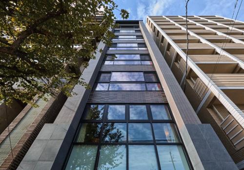 a tall building with glass windows on the side at Sekia Wagaya Hotel in Karahashi Rashomon