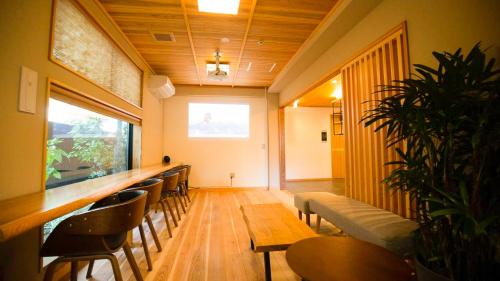 a bar with chairs and a long counter in a room at NK Hotels in Fukuoka