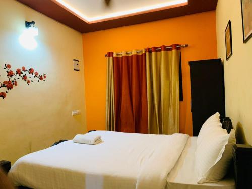 a bedroom with a bed and a curtain at Vythiri Misty Wind Holiday Homes in Vythiri
