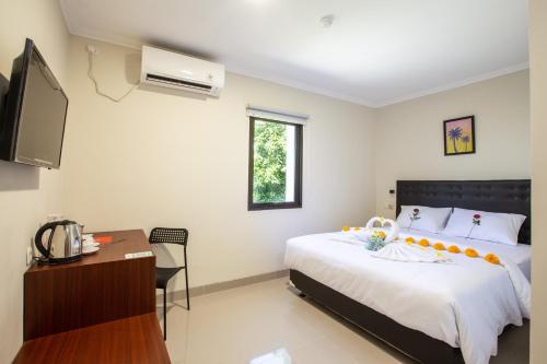 En eller flere senger på et rom på Liberta Home Seririt Bali