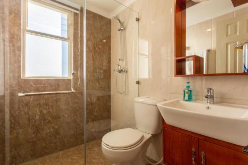 a bathroom with a toilet and a sink and a shower at Swayambhu Hotels & Apartments- Sitapaila in Kathmandu