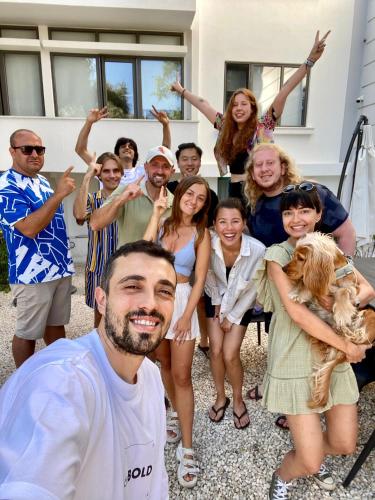 a group of people standing in front of a house at BE BOLD HOSTEL in Antalya