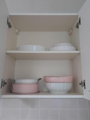 a kitchen shelf with bowls and other dishes on it at La Casetta di Treville in Ozzano Monferrato